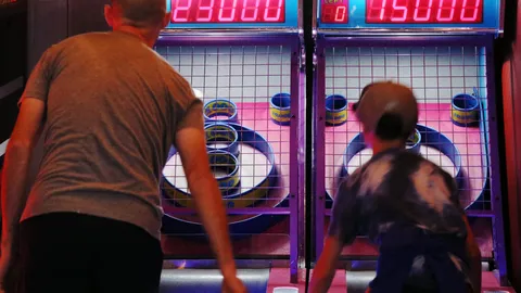 Father and son playing iceball (ski-ball) at FlagTagAZ in Flagstaff Arizona